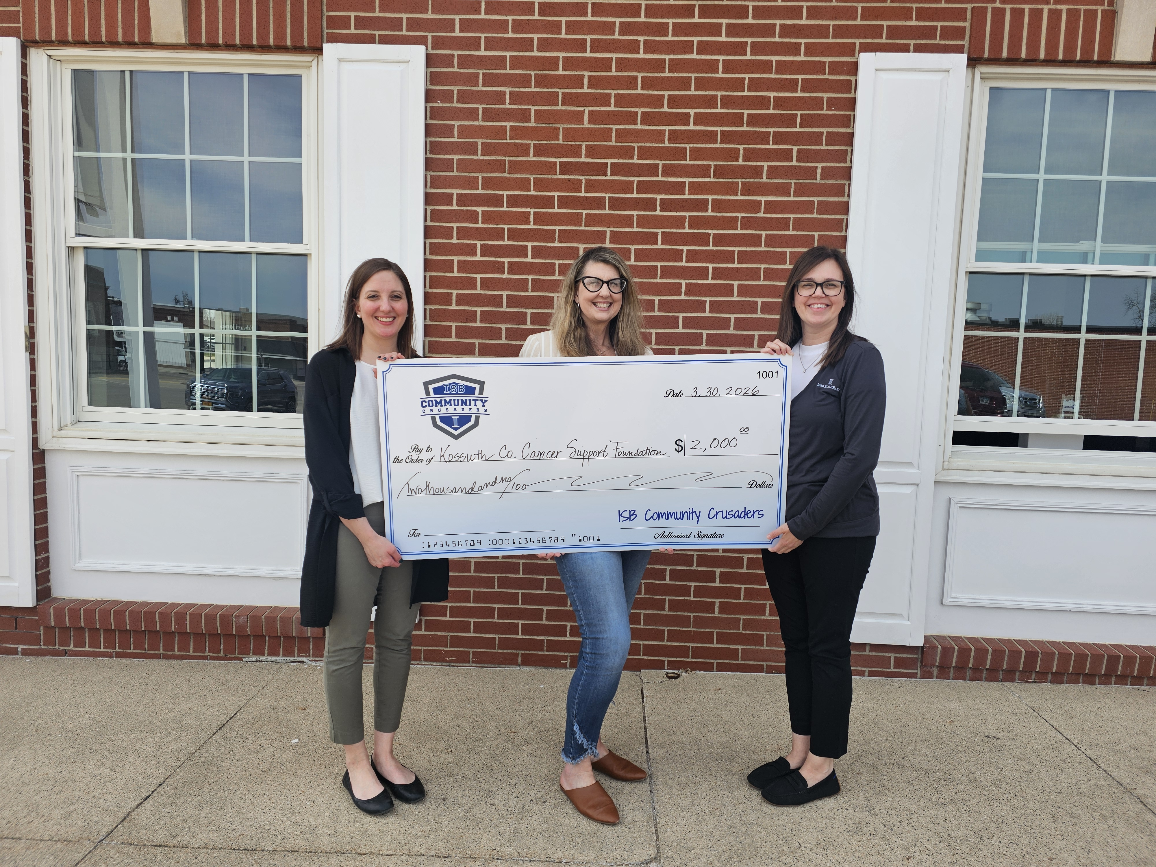 Bank employees present check to Kossuth County Cancer Support Foundation