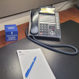 Business phone, notepad and pen