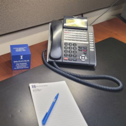 Phone on desk with note pad
