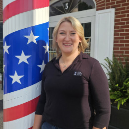 Tana Schultze next to bank exterior wrapped in patriotic decor